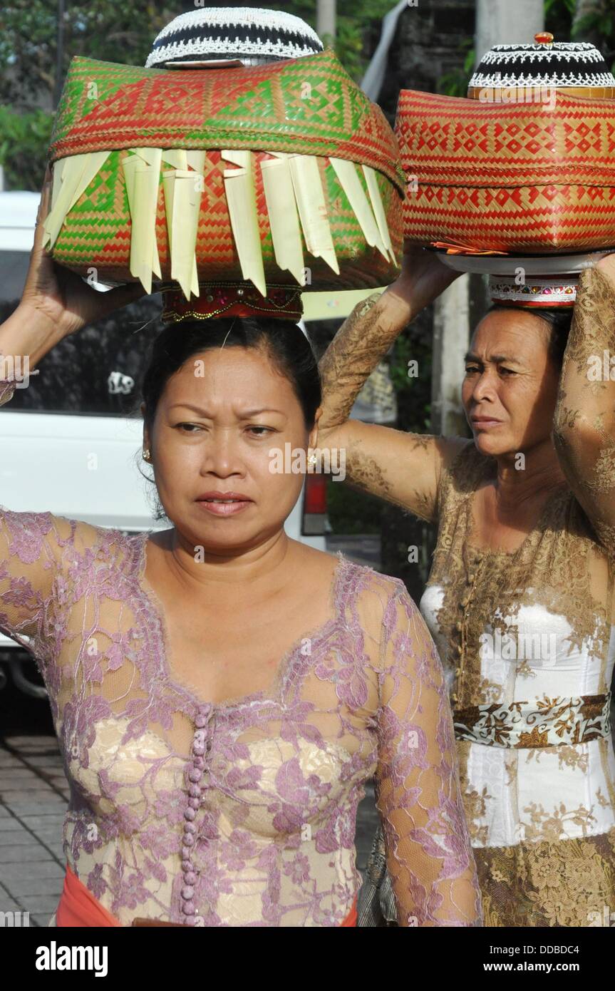 Ubud (Bali, Indonesia) women in traditional dress, carrying a basket