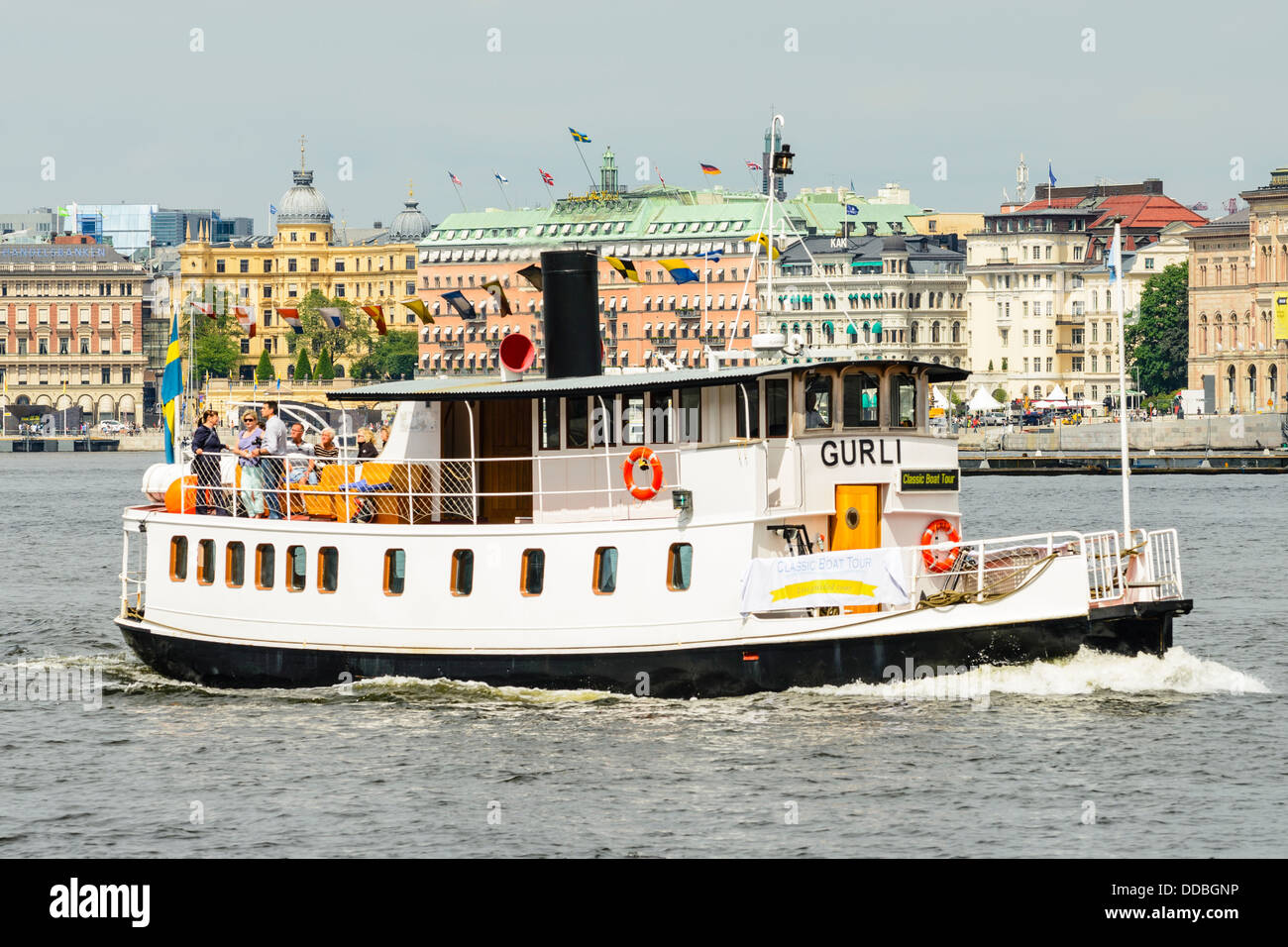 Sightseeing boat 'Gurli' at Norrstrom Stockholm Sweden with the Grand Hotel behind Stock Photo