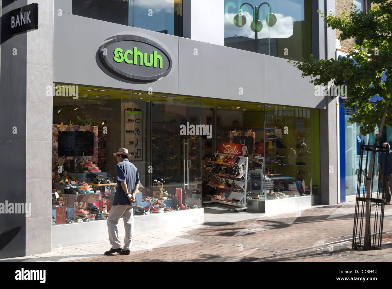 man looks in the window of the footwear retailer schuh, in kingston upon thames, surrey, england Stock Photo