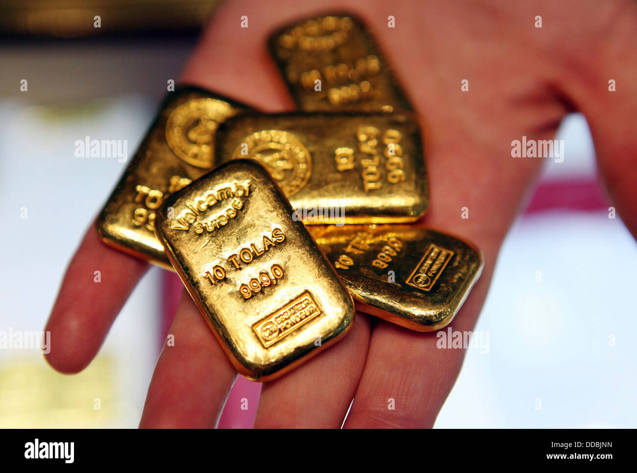 Dubai, United Arab Emirates, gold bars on one hand Stock Photo