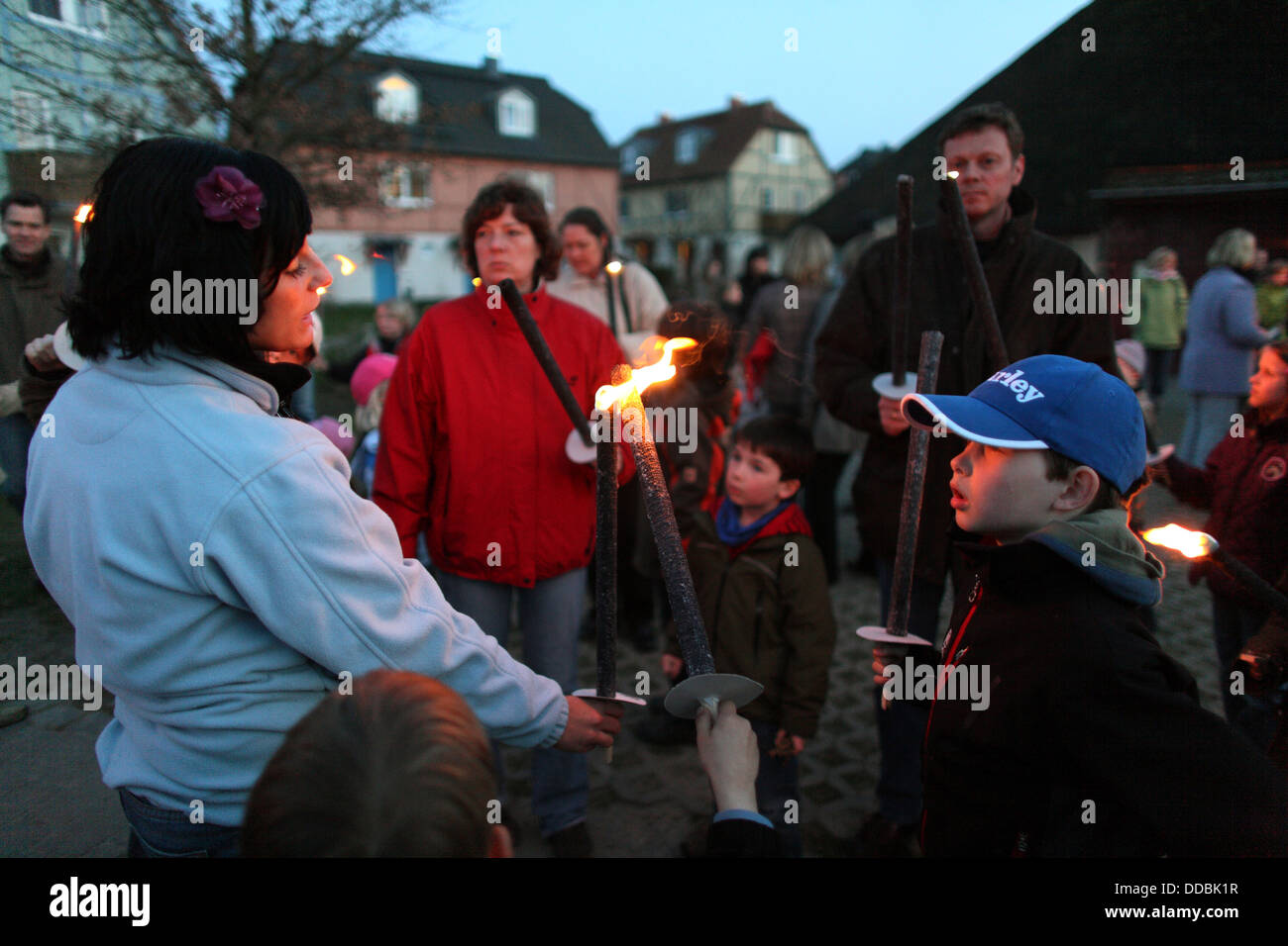 Waren, Germany, Mrs. builts the torch of a child Stock Photo