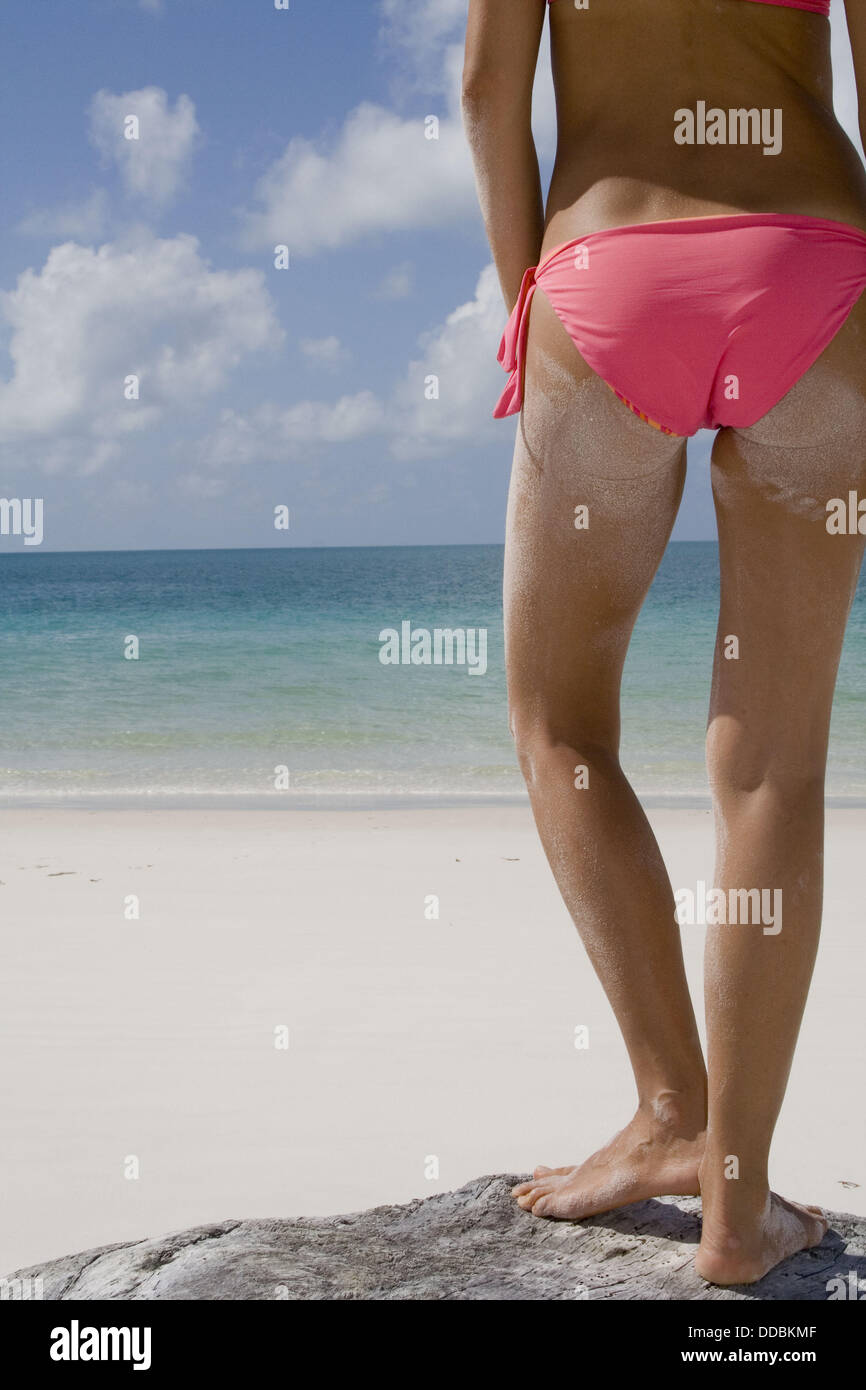 Woman in bikini bottoms, seen from behind, standing on Whitehaven Beach,  Australia Stock Photo - Alamy