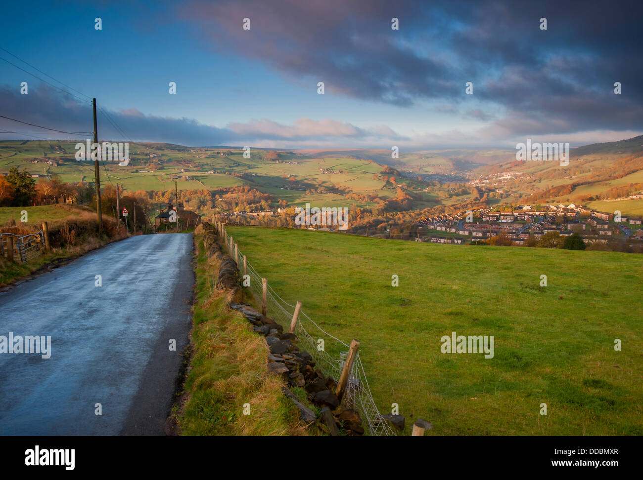 a wet tarmac road overlooking a yorkshire dales valley on a blustery autumn morning. Stock Photo