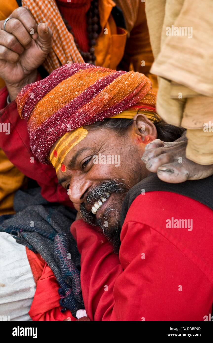 A sadhu gets a back massage from his friend Stock Photo Alamy