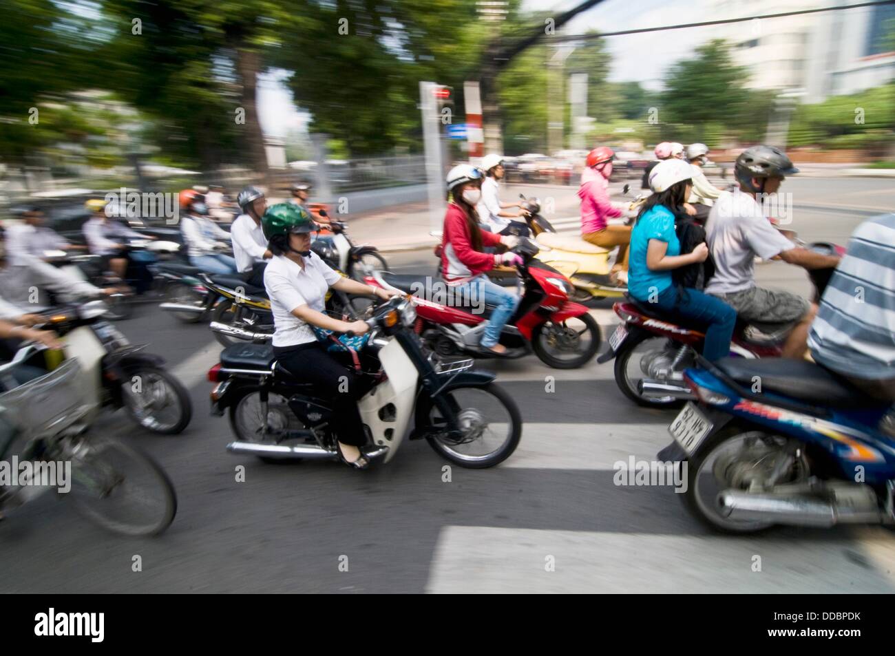 Heavy traffic consisting of many scooters during rush hour in Saigon. Stock Photo