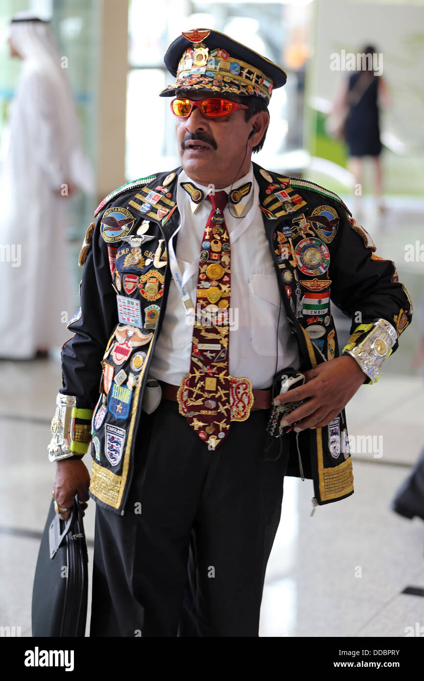 Dubai, United Arab Emirates, man carries a decorated with buttons and patches Jacket and Beanie Stock Photo