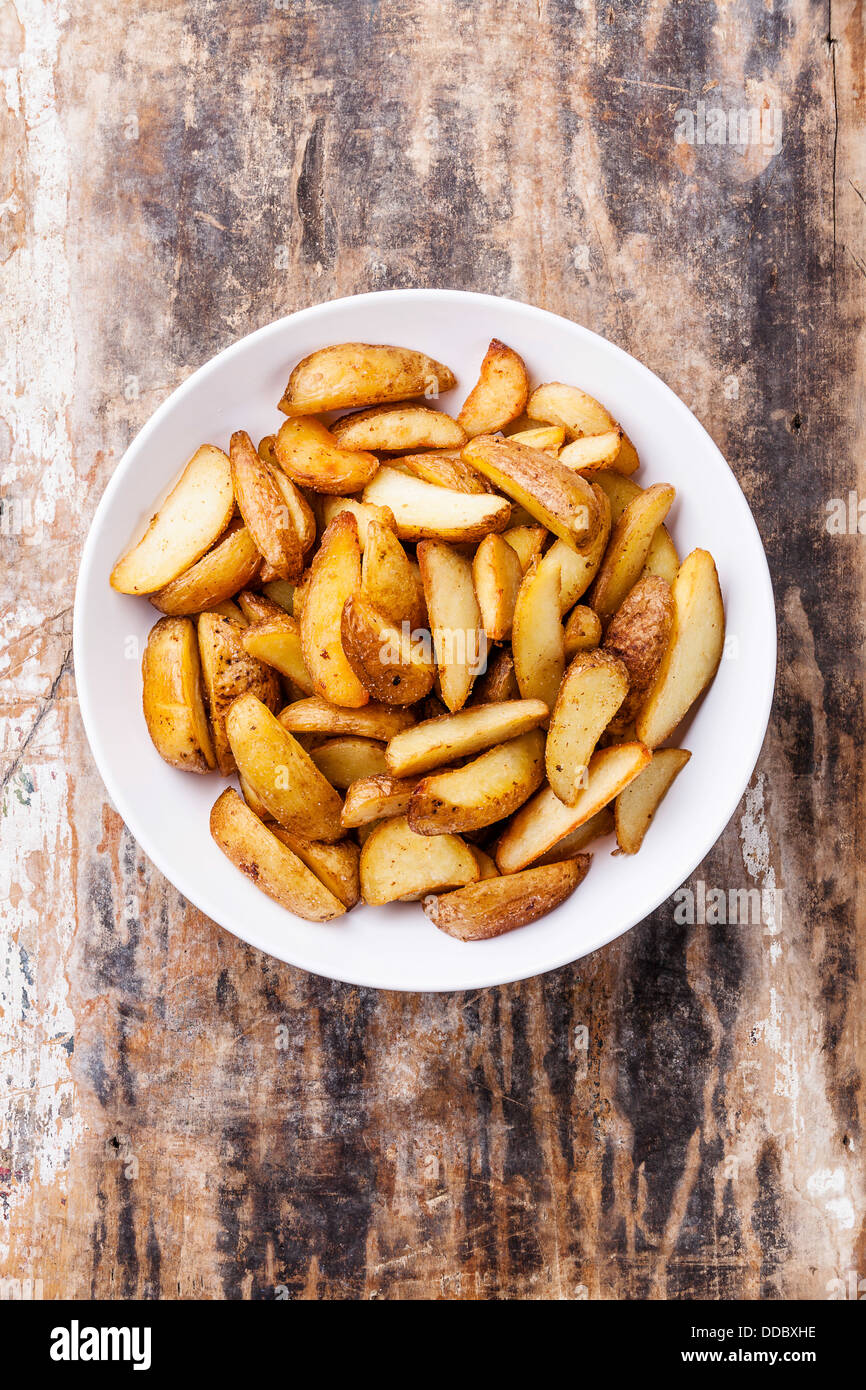 Fried potato 'country-style' chips on plate Stock Photo