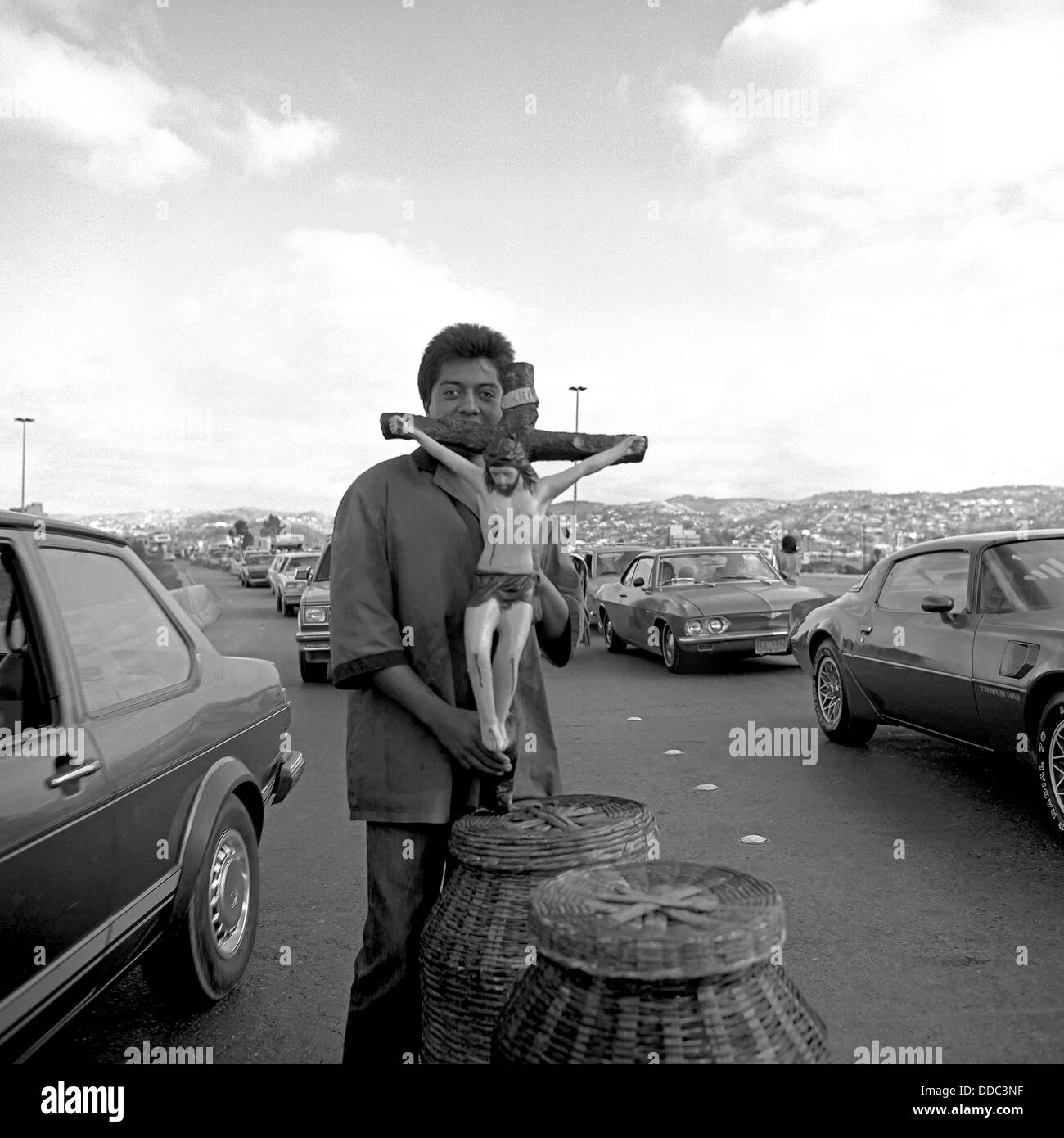 Mexican man sells statue of Jesus on Tijuana border. Stock Photo