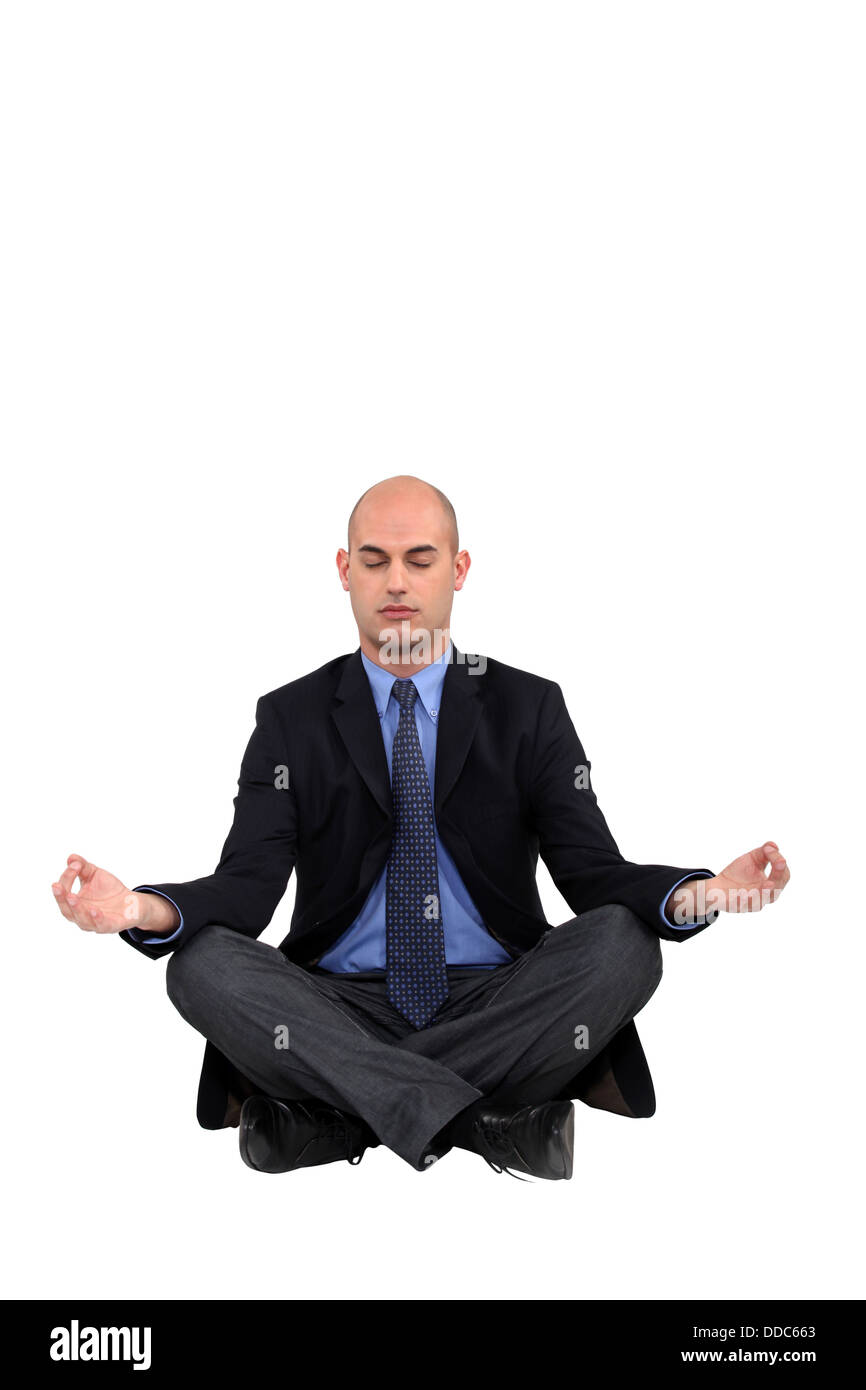 Businessman in a yoga position Stock Photo - Alamy