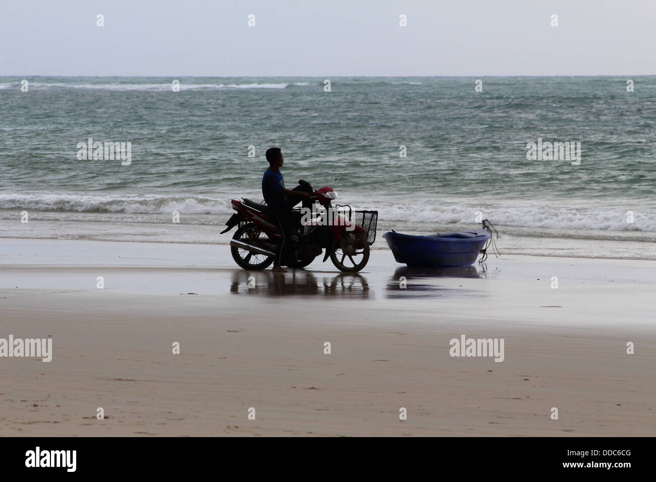A fisherman on his way to his boat Stock Photo