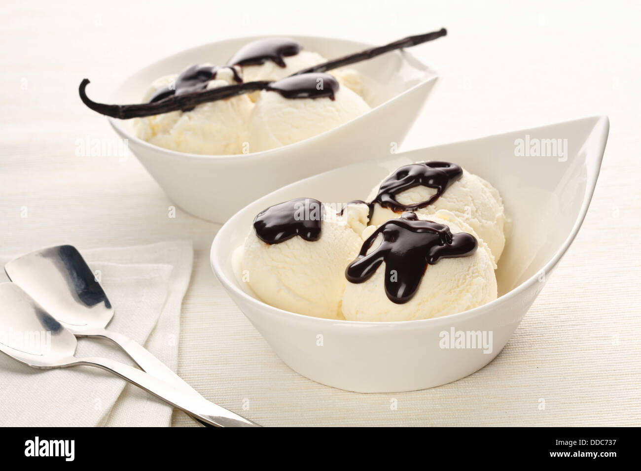 Vanilla ice cream with dark chocolate on white background Stock Photo