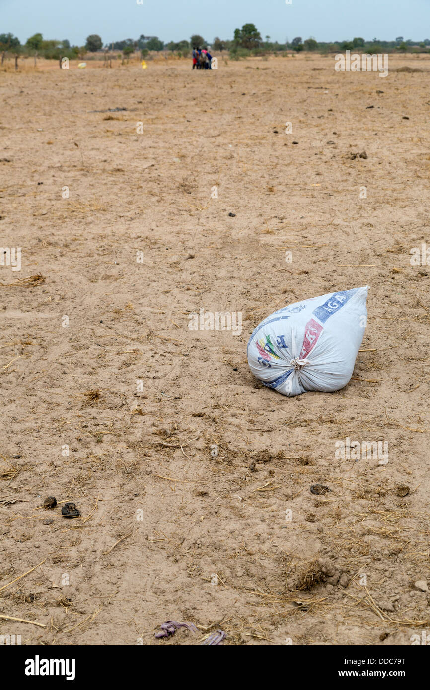 Millet Cultivation. Bag of Compost Awaits Planters. Kaolack, Senegal. Stock Photo