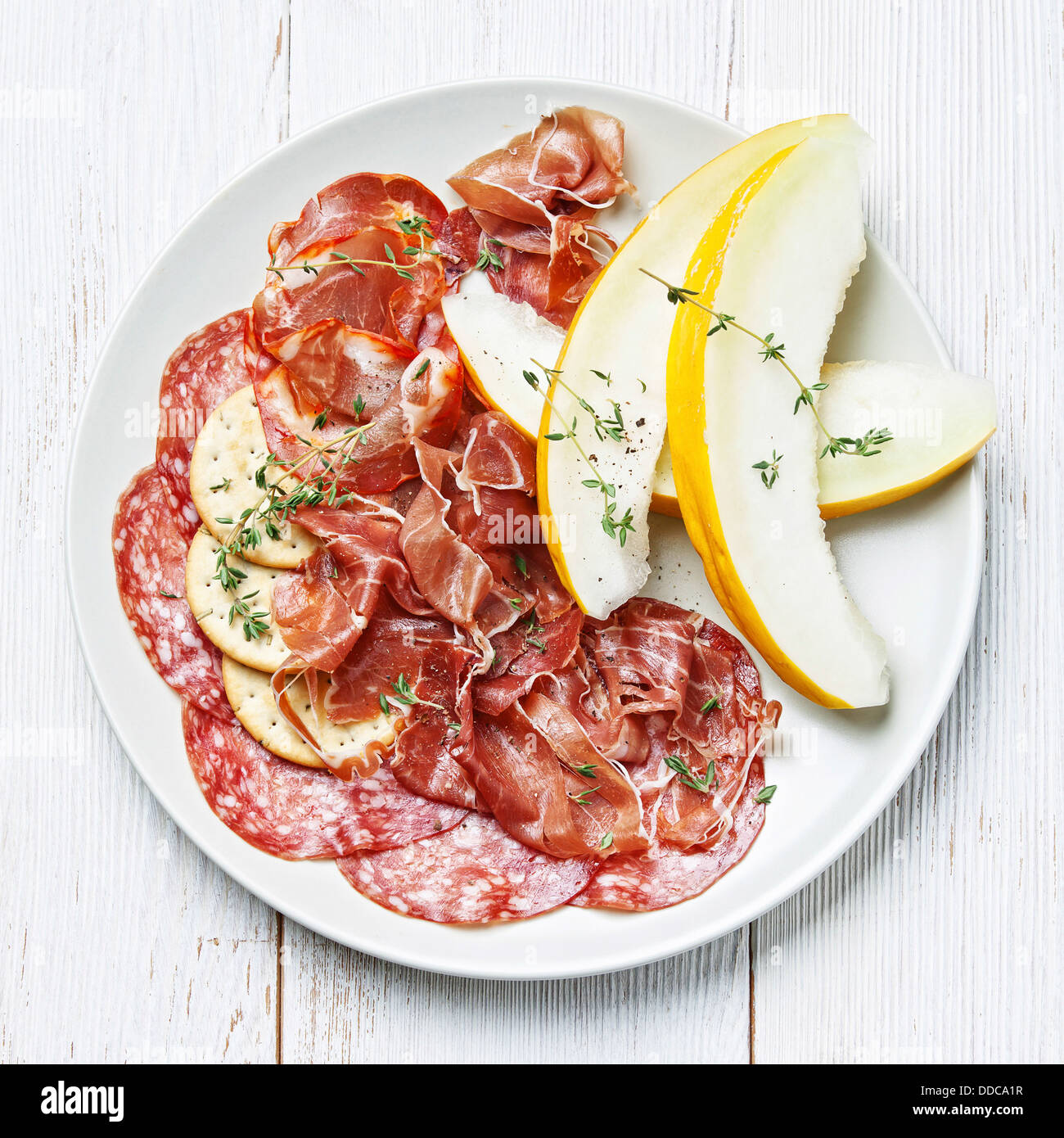 Platter of Assorted Cured Meats and Melon Stock Photo