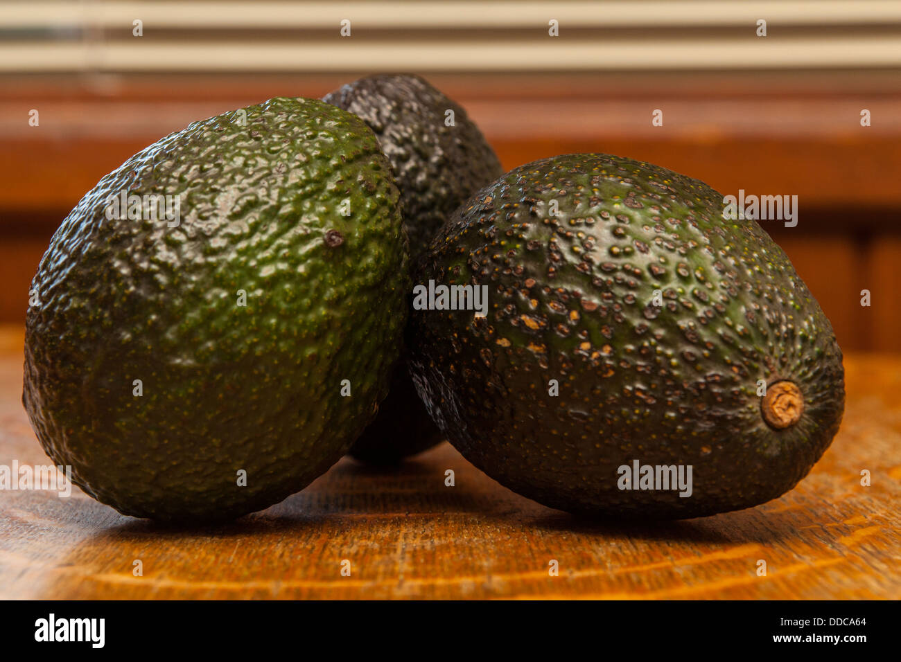 Hass Avocados on a old wooden table Stock Photo - Alamy