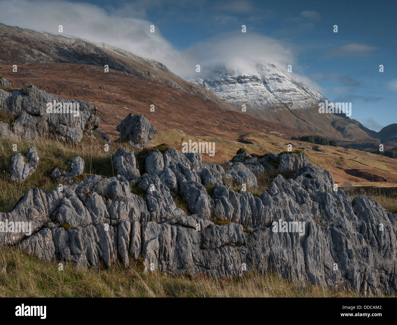 A view towards the snow-covered mountain Conival from Inchnadamph, Scottish Highlands UK Stock Photo