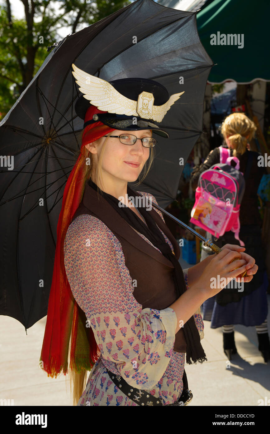 Pretty young woman with umbrella at the steampunk festival in Coldwater ...