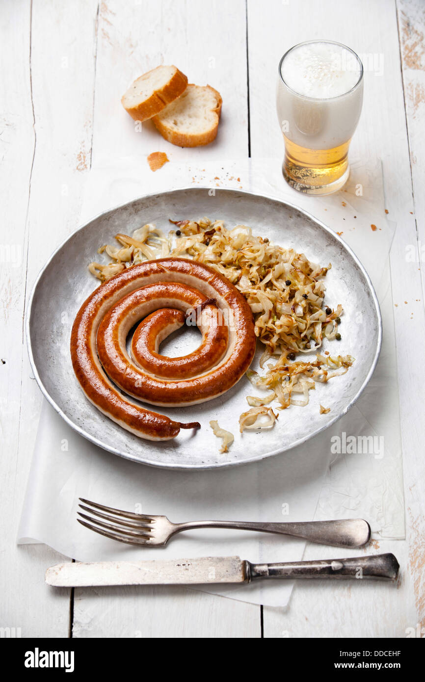 Roasted sausage with stewed cabbage and beer Stock Photo