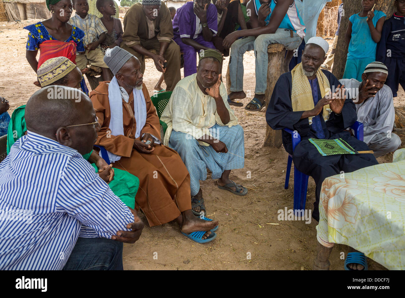 Manager of Non-profit NGO (western dress) Speaks to Men at Microcredit Meeting, Djilor, a Wolof Village, near Kaolack, Senegal. Stock Photo