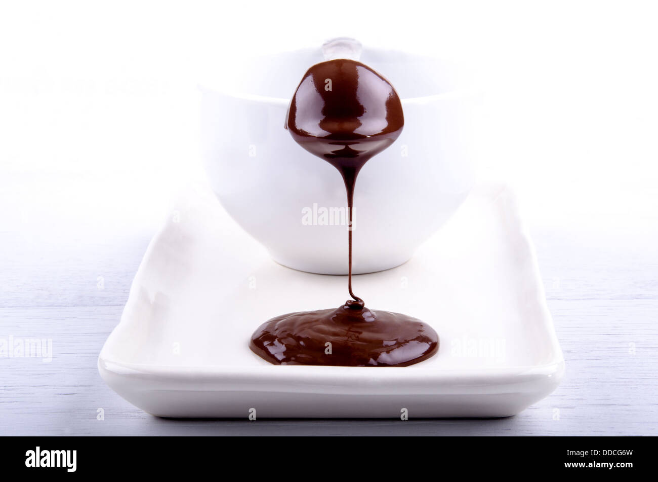 melted chocolate flows over a praline Stock Photo