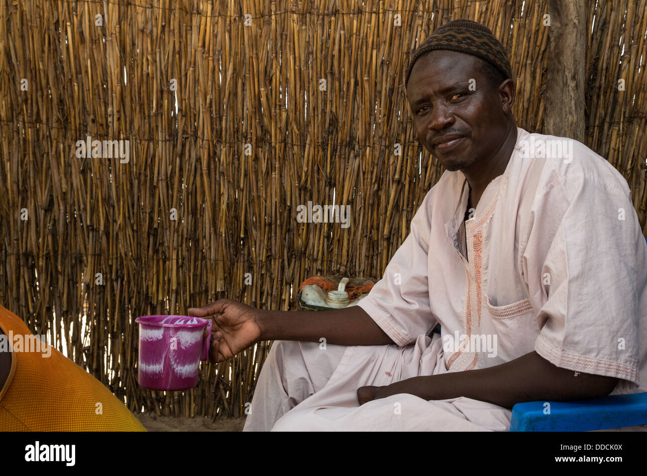 Senegalese Farmer with Cup of Tea. Bijam, a Wolof Village, near Kaolack, Senegal. Stock Photo