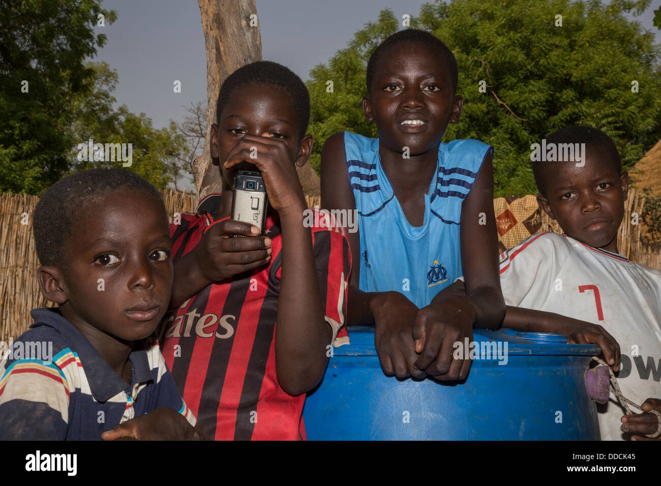Senegalese Boys in a Rural Village, one with a Mobile Camera Phone. Bijam, Senegal. Stock Photo