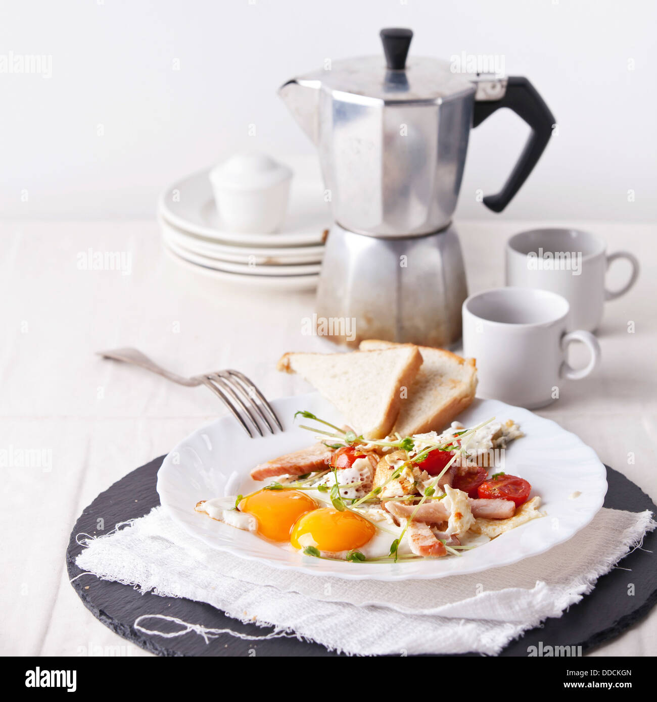 Ham and egg breakfast with toast, coffee and salad Stock Photo