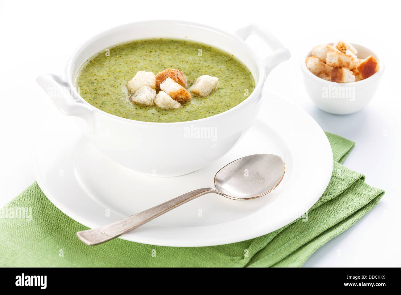 Broccoli soup with croutons on white background Stock Photo
