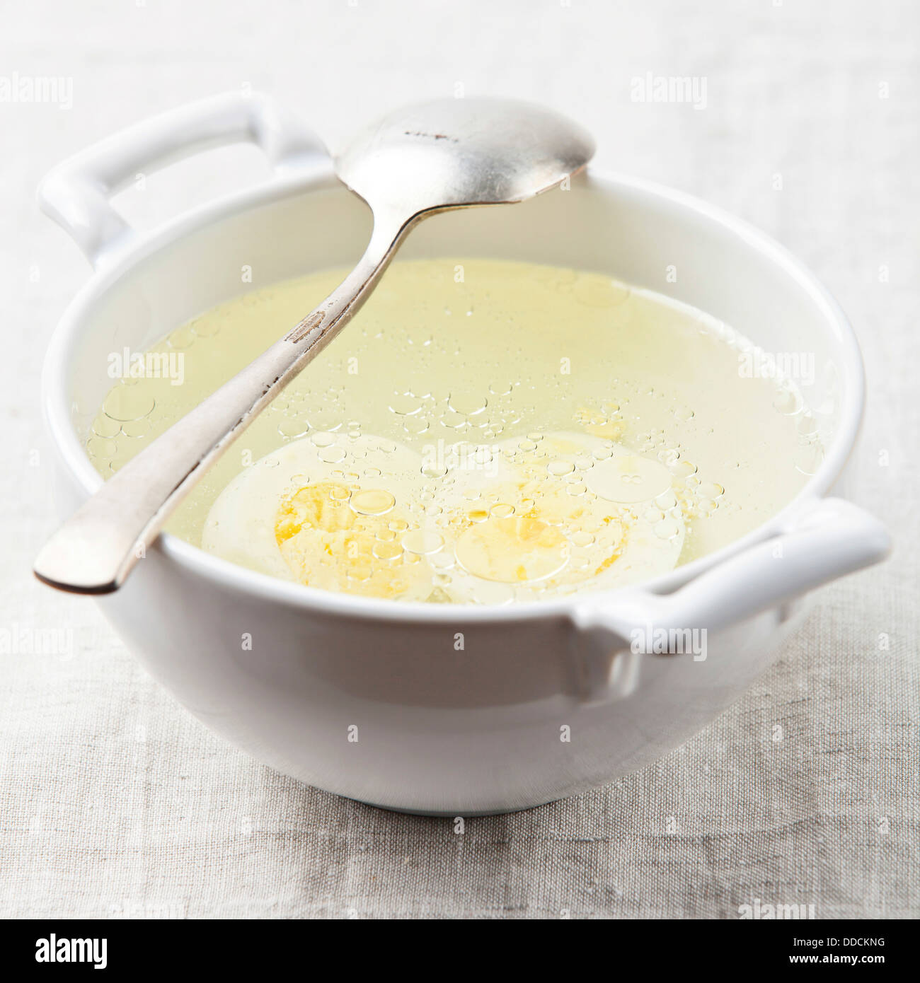 Served place setting with chicken broth Stock Photo