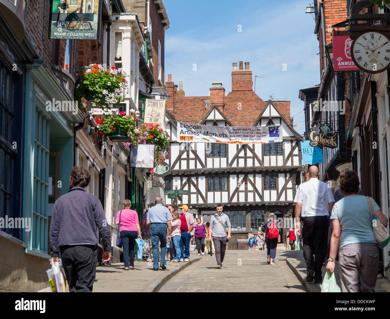 Steep Hill with people shopping and half-timbered building at top, Lincoln, England Stock Photo