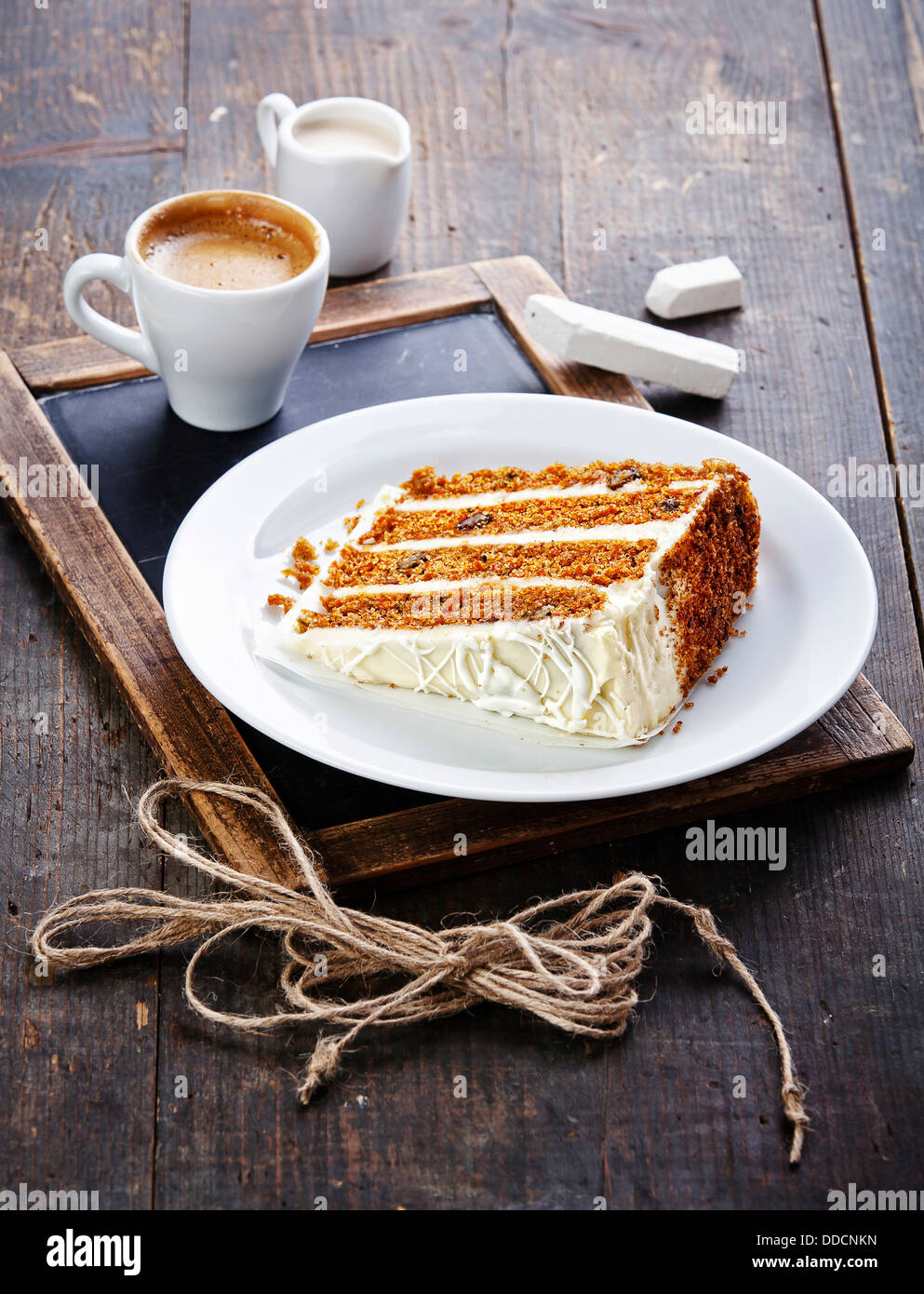 Slice of carrot cake on vintage slate chalk board background Stock Photo