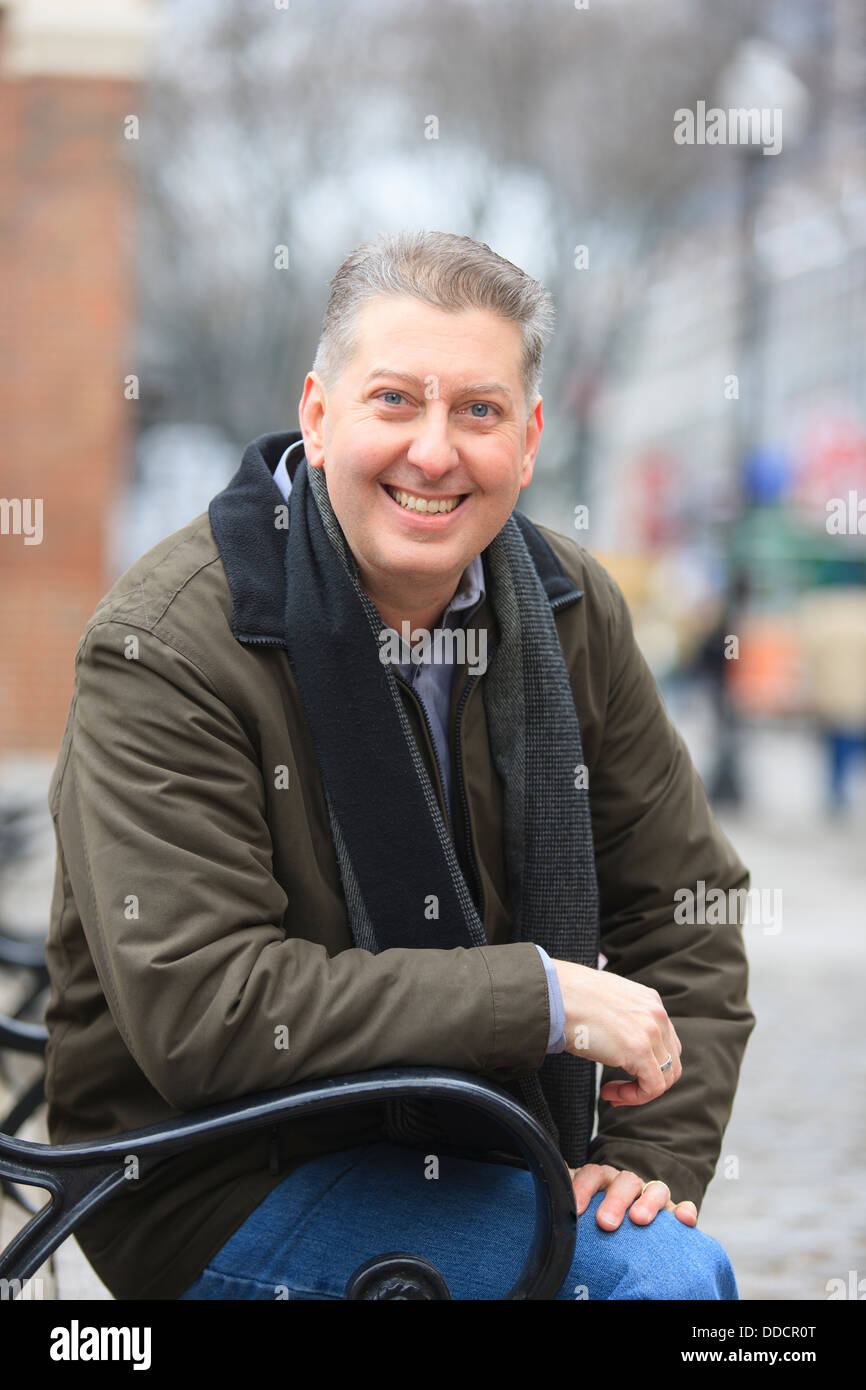 Adult man sitting on bench hi-res stock photography and images - Alamy