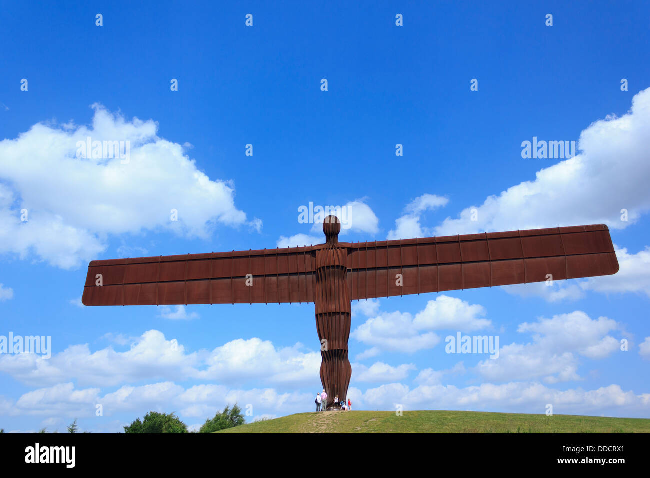 Angel of the North being visited by tourists on a sunny day in Newcastle, England. Stock Photo