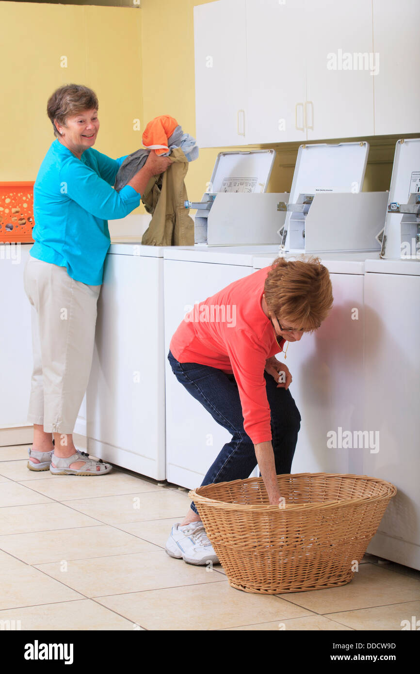 Two senior women doing laundry Stock Photo Alamy