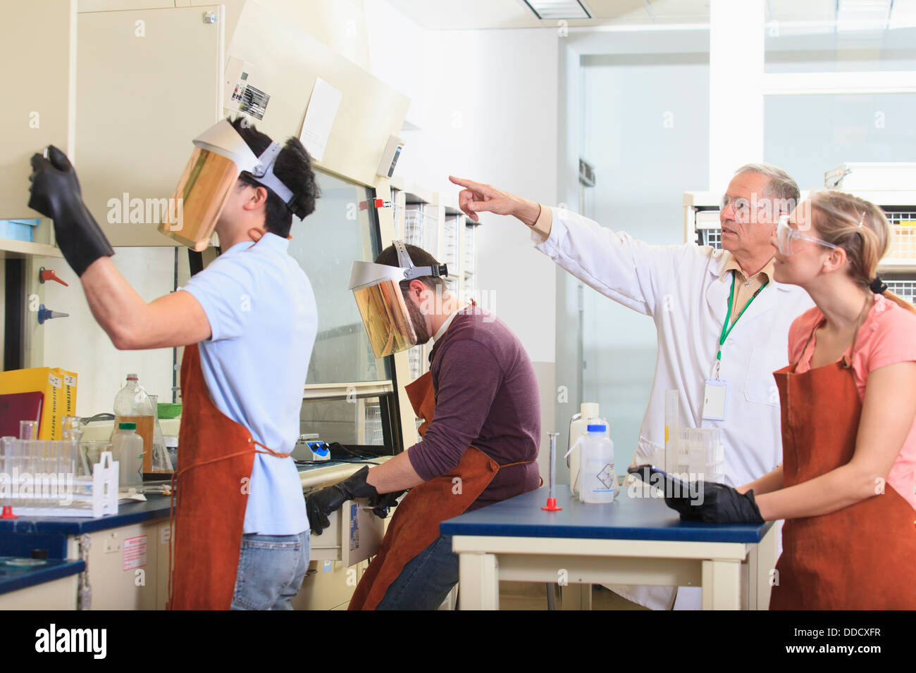 Student wearing protective apron in science lab hires stock