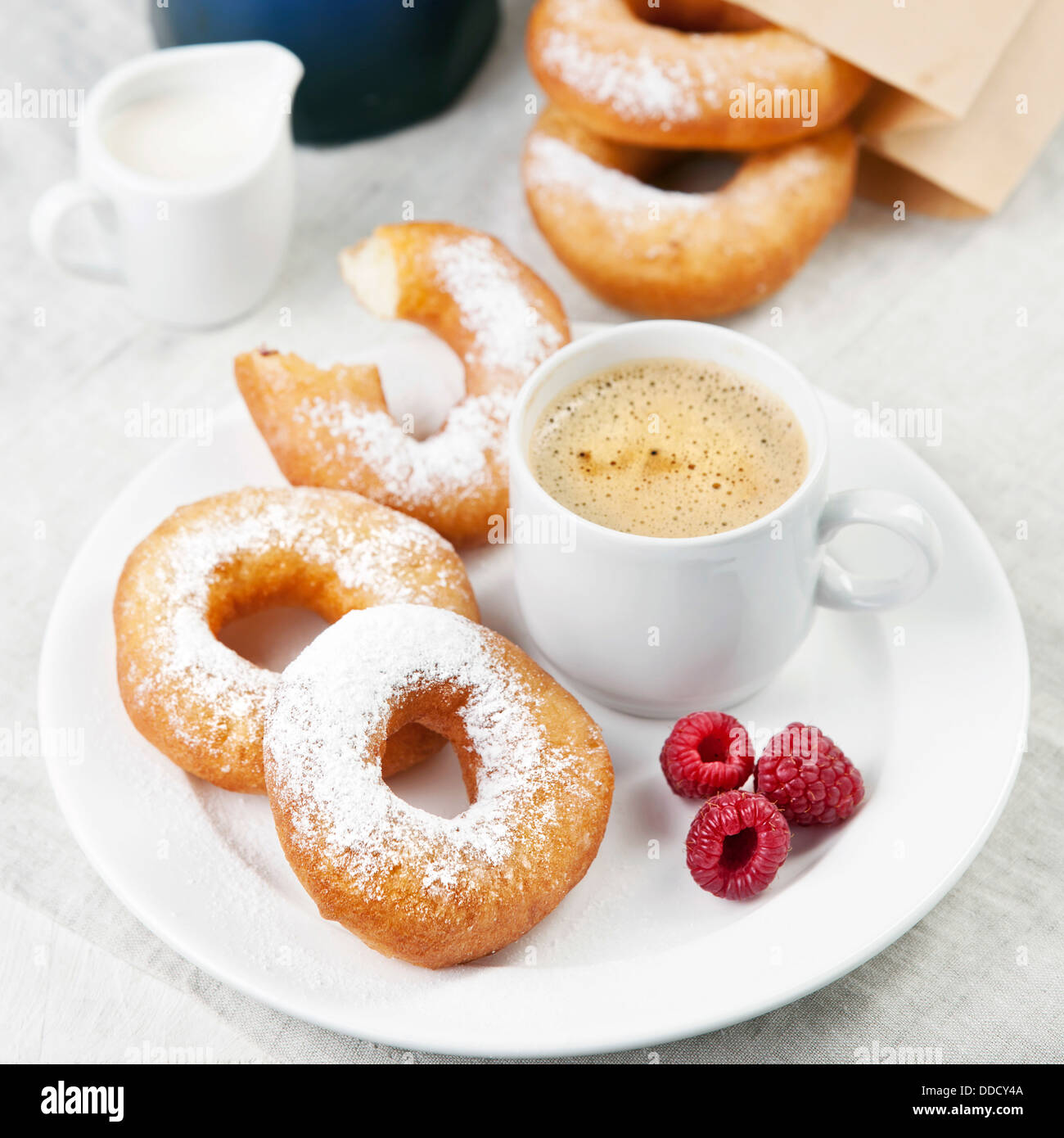 Donuts and coffee on morning breakfast table Stock Photo Alamy