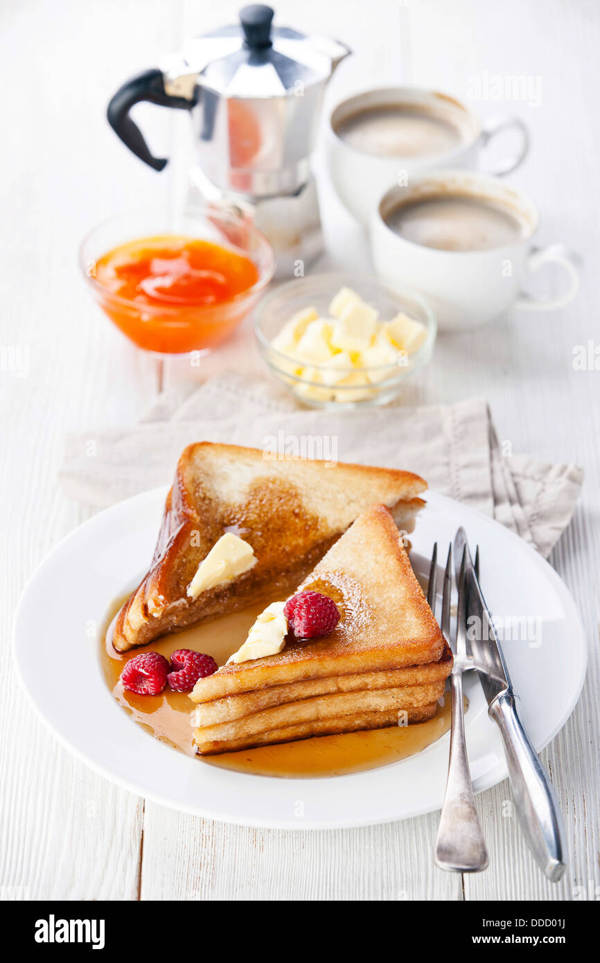 French toast with raspberries, maple syrup and butter Stock Photo