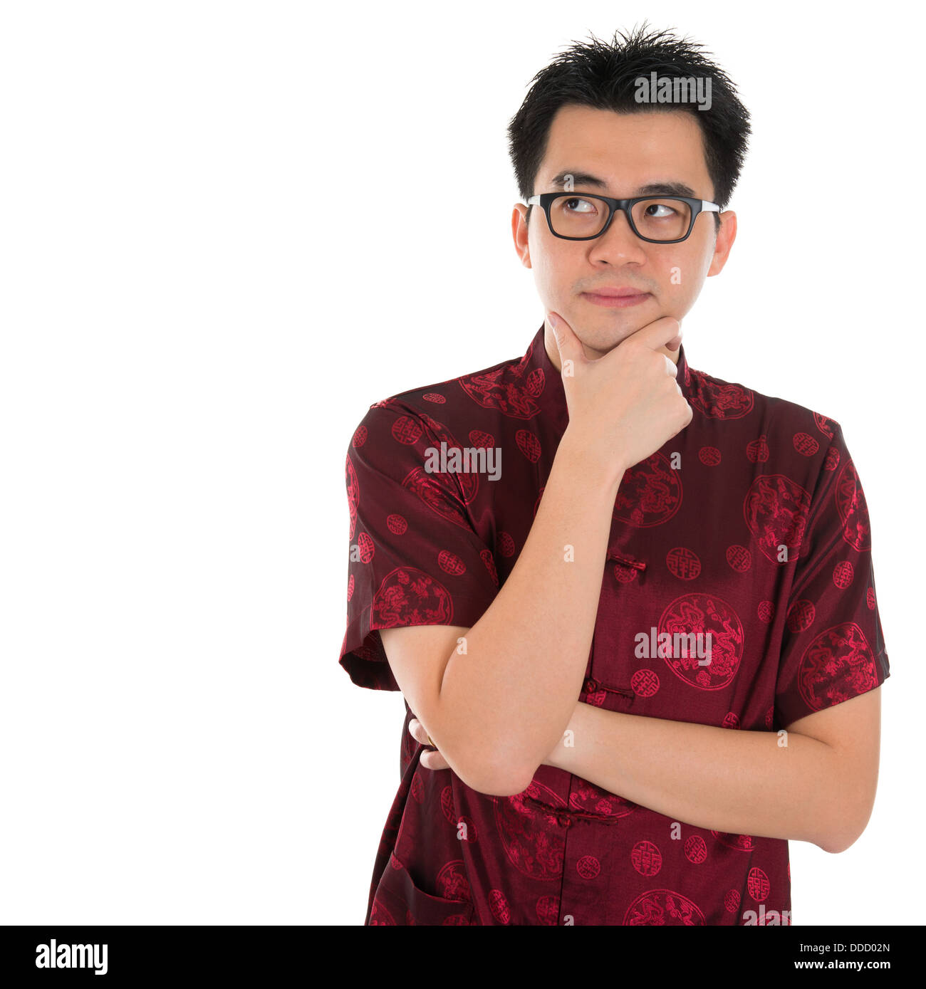 Asian man with Chinese traditional cheongsam or tang suit having a thought. Male model isolated on white background. Stock Photo