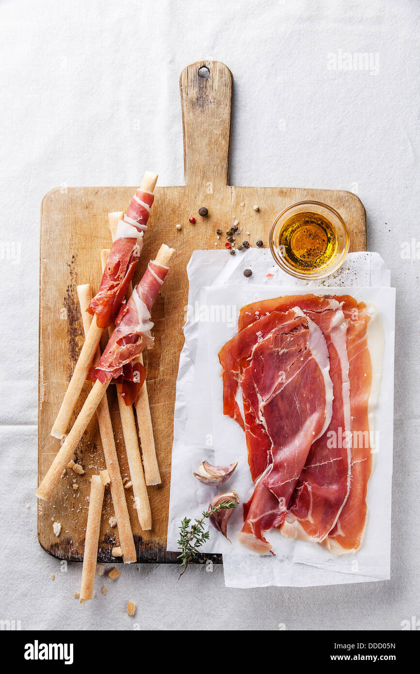 Bread sticks with ham on wooden cutting Board Stock Photo
