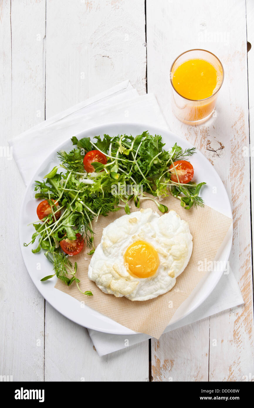 Breakfast baked egg with salad Stock Photo