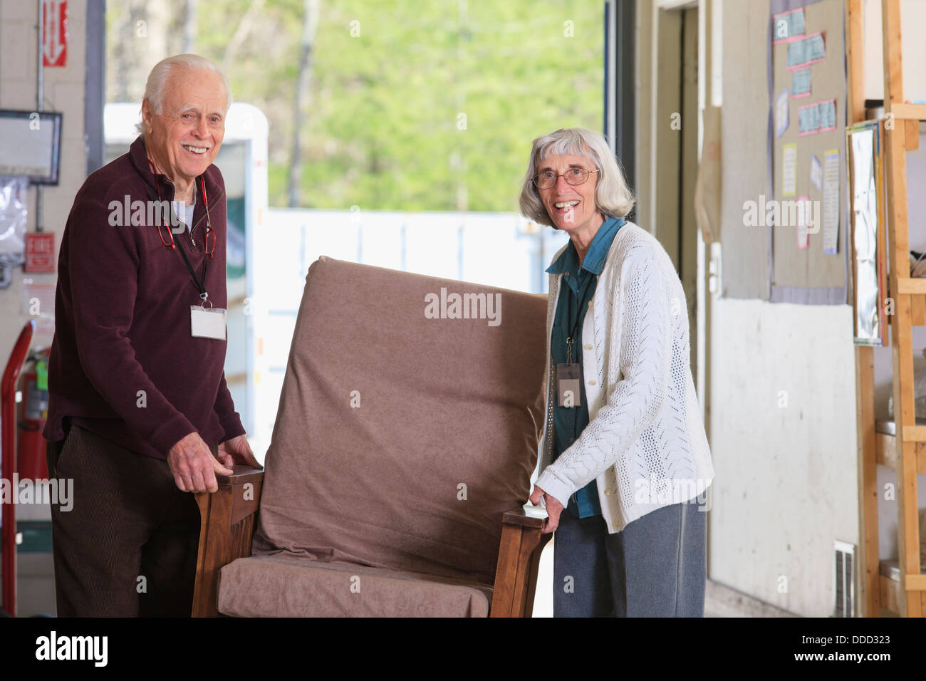 Senior couple moving furniture in a warehouse Stock Photo Alamy