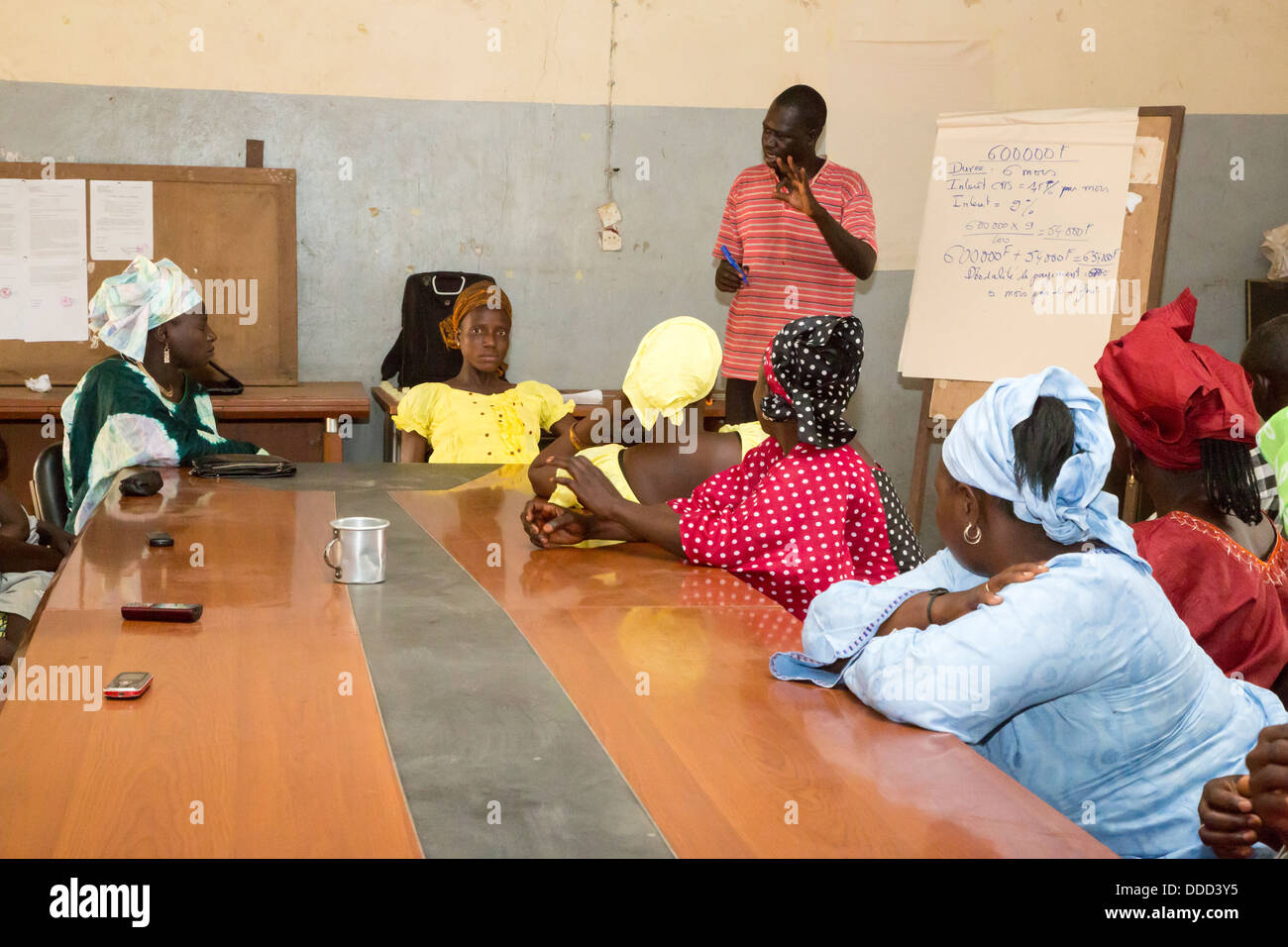 Microfinance. Women Receiving Instruction in how to estimate costs of planting and fertilizing a crop. Kaymor, Senegal Stock Photo