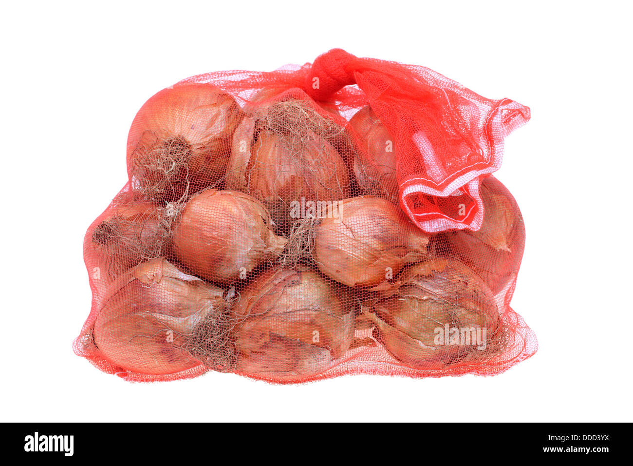 fresh onions in a red plastic net on a white background Stock Photo