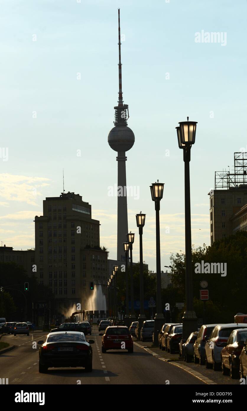 Cars drive on Karl-Marx-Allee street towards Strausberger Platz square with ols street lamps and the TV tower in the background, in the evening in Berlin, Germany, 28 August 2013. Photo: JENS KALAENE Stock Photo
