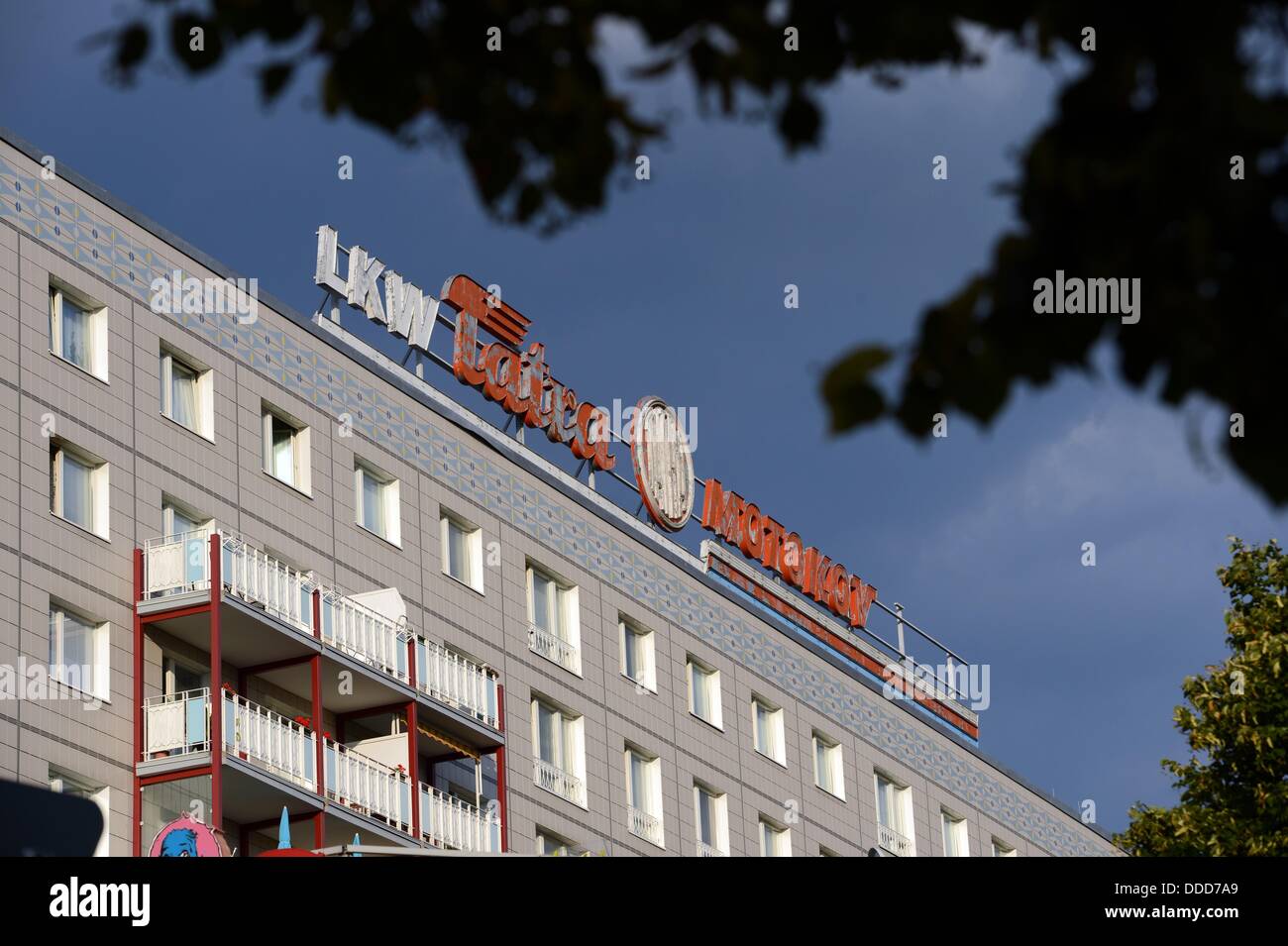 A historical neon sign reading 'LKW Tatra Motokov' is photographed on an  apartment building on Kalr-Marx-Allee street in Berlin, Germany, 28 August  2013. Photo: JENS KALAENE Stock Photo - Alamy
