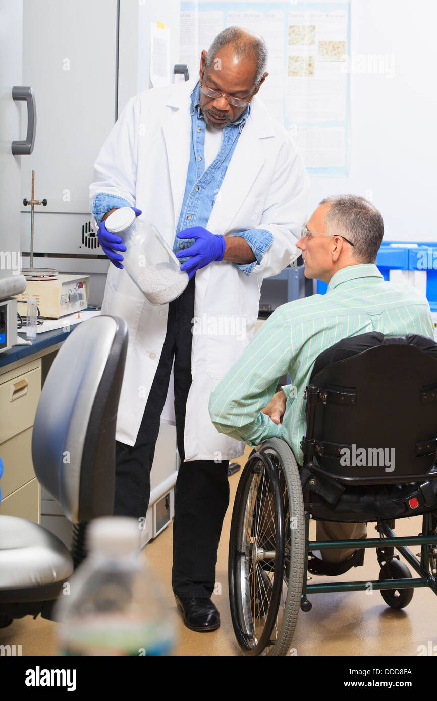 Two professors in a chemistry lab one with a spinal cord injury looking