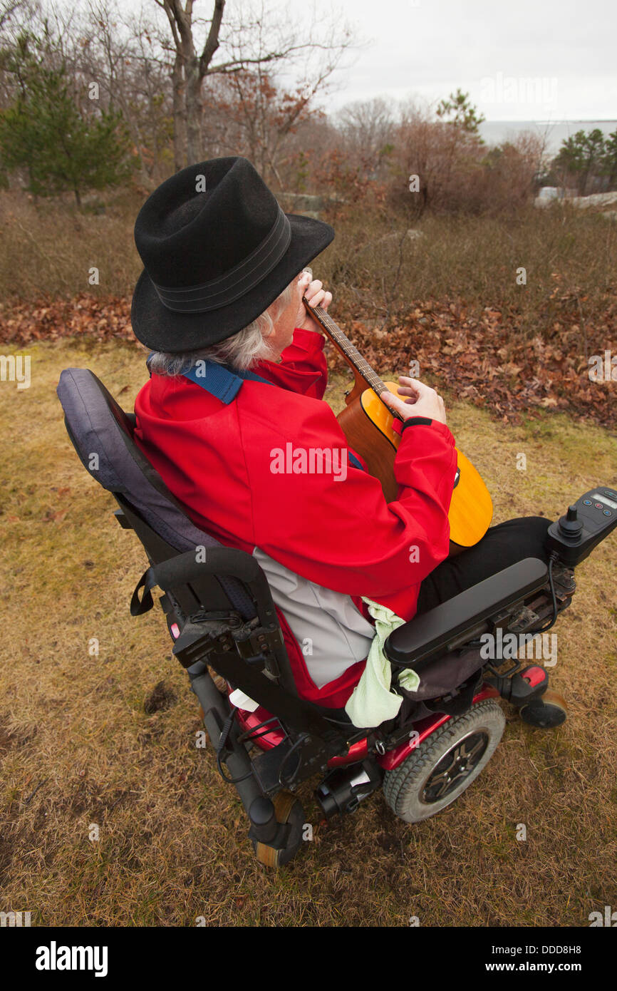 Man With Multiple Sclerosis In A Motorized Wheelchair Enjoying His Back 