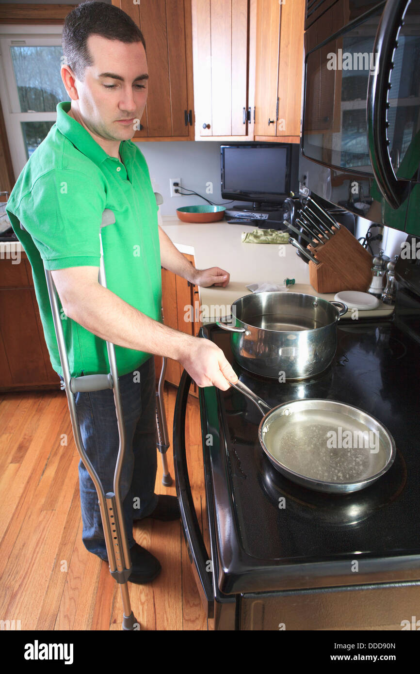 Man after anterior cruciate ligament (ACL) surgery with crutches