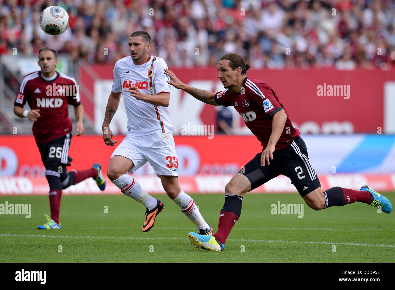 Nuremberg, Germany. 31st Aug, 2013. Nuremberg's Emanuel Pogatetz (R) vies for the ball with Augsburg's Sascha Moelders during the Bundesliga soccer match between 1. FC Nuremberg and FC Augsburg at Grundig Stadium in Nuremberg, Germany, 31 August 2013. Photo: DAVID EBENER (PLEASE NOTE: Due to the accreditation guidelines, the DFL only permits the publication and utilisation of up to 15 pictures per match on the internet and in online media during the match.)/dpa/Alamy Live News Stock Photo