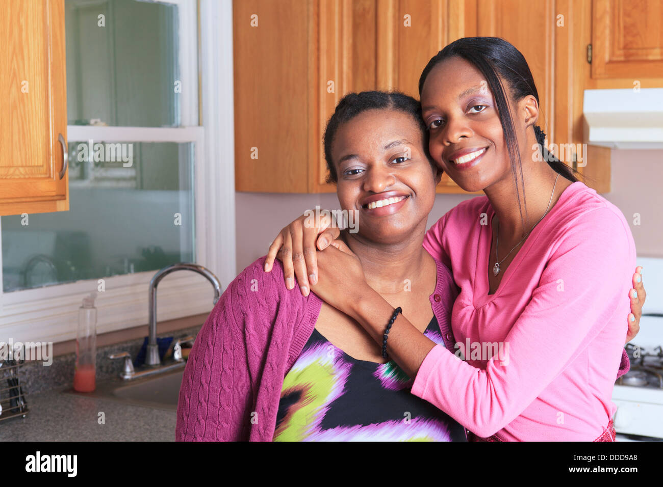 Portrait of two sisters smiling, one with learning disability Stock Photo