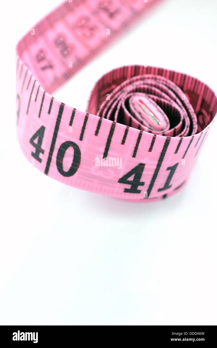 Pink tape measure isolated on white background Stock Photo - Alamy